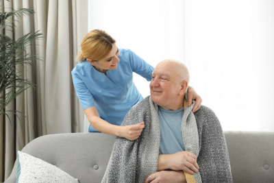 caregiver and senior man smiling